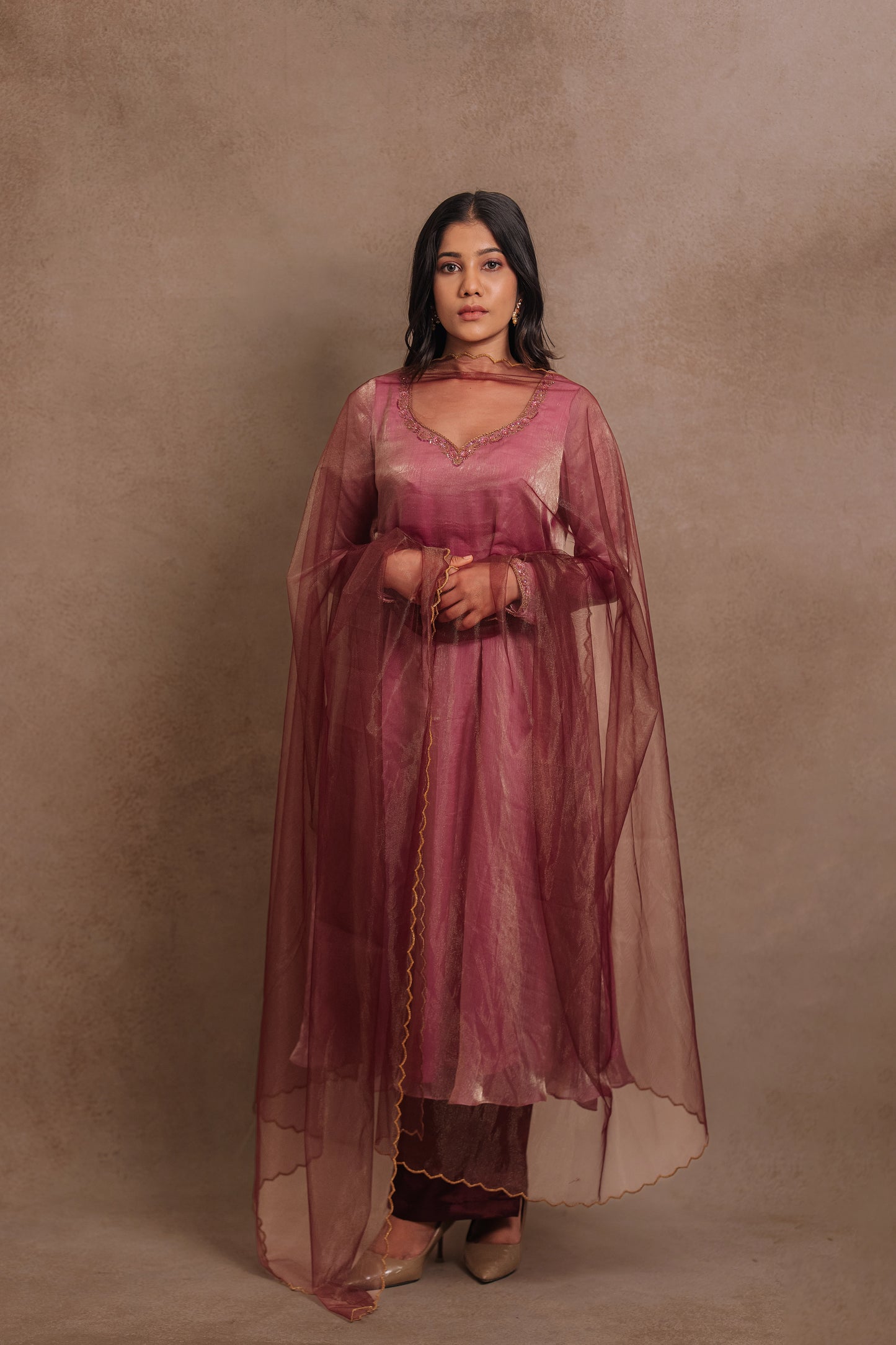 Model Jaina Parmar in a hand embroidered tissue chiffon anarkali in onion pink (dual tone), paired with an embroidered tulle dupatta in wine red by team AKloset.