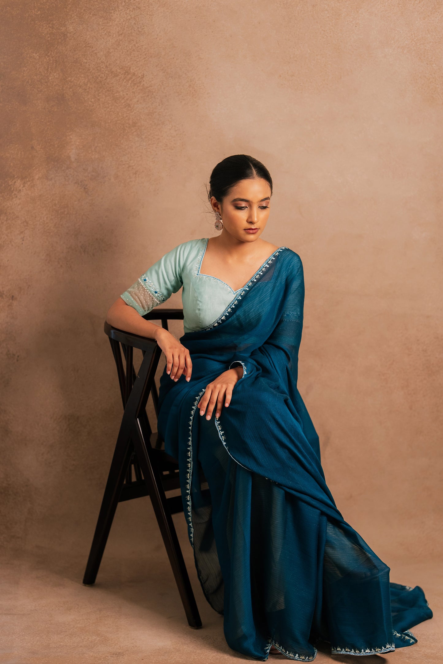 Model Krisha Embroidered shimmer chiffon saree in teal paired with a chanderi blouse in muted turquoise with pearl beads detailing by team AKloset.