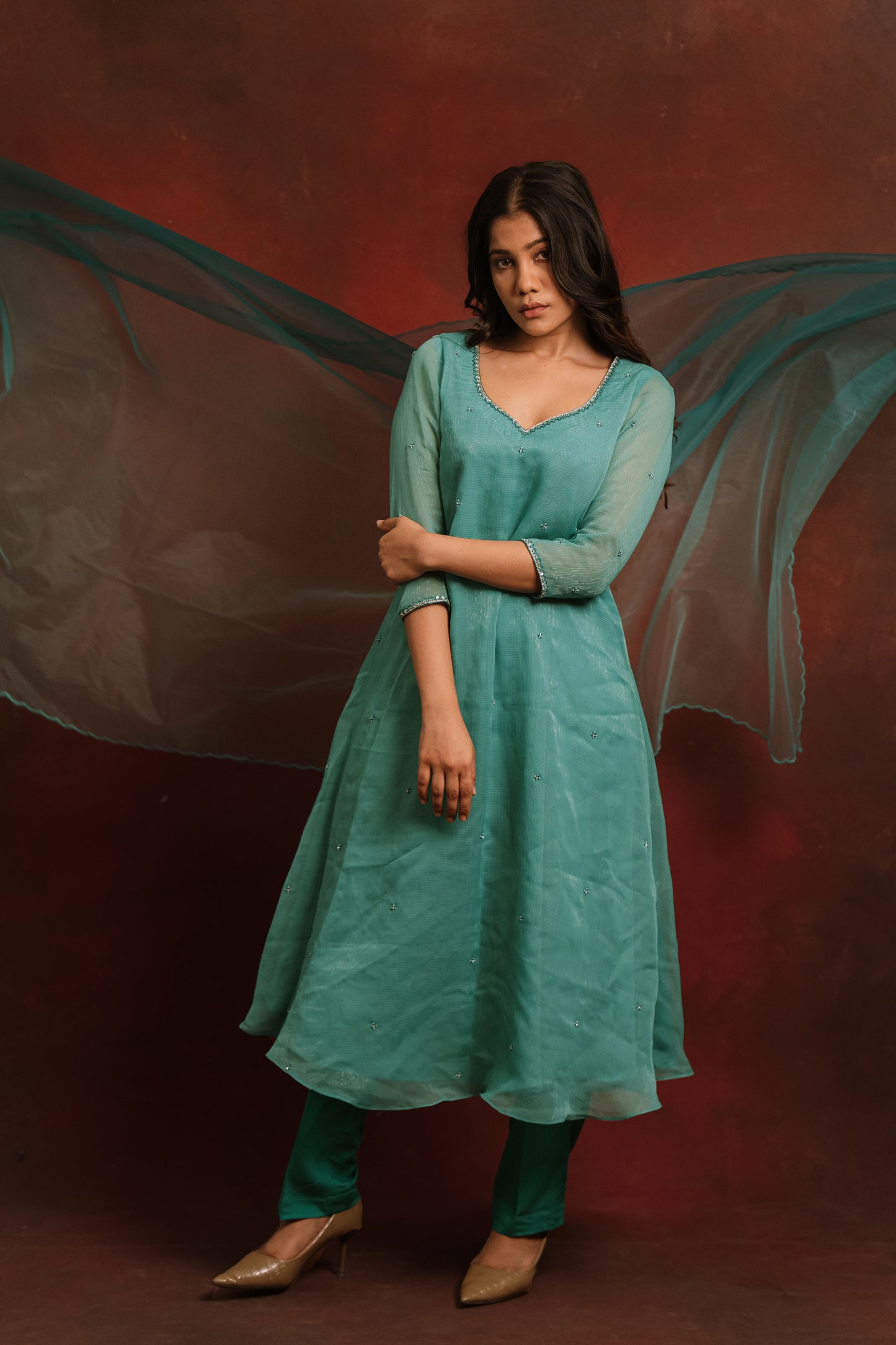 Model in a teal blue tissue chiffon salwar set by AKloset.